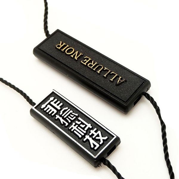 廠家直銷通用雙插服裝吊粒新款創(chuàng)意服裝掛繩方形立體塑料飛機頭標(biāo)簽繩